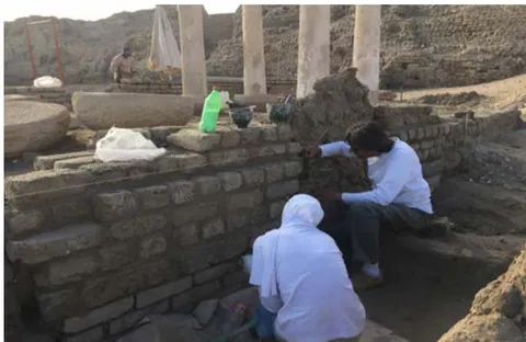 Figure 35: The conservators treat the wall after straightening & supporting.