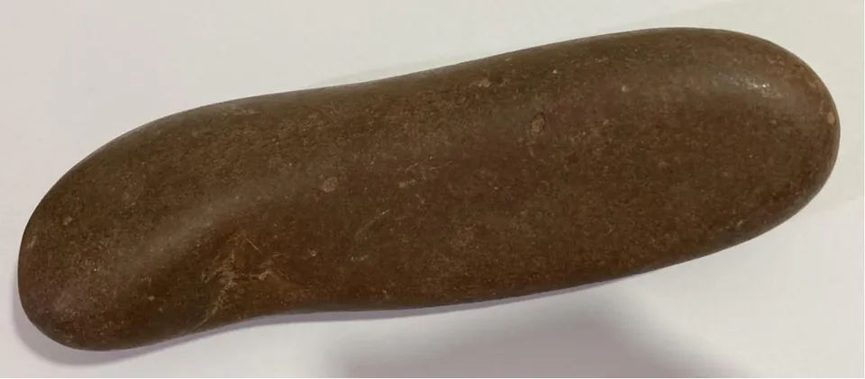 a autora. O artefato é um amuleto. Comprimento: 20 cm. Largura: 6 cm. Espessura: 5 cm. Peso: 1.013 kg.