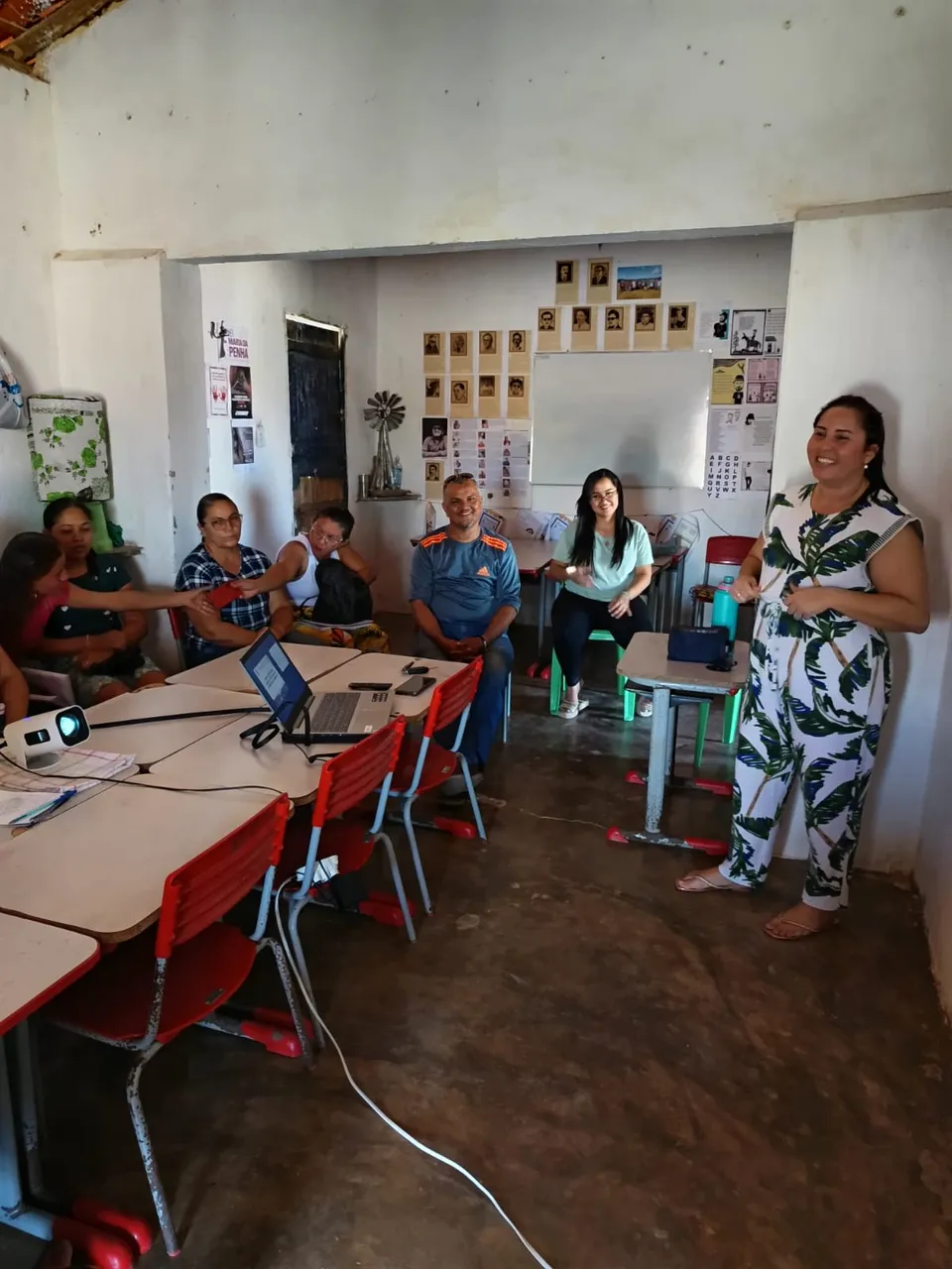 Instructor introducing the plant extraction course to community participants seated in a classroom.