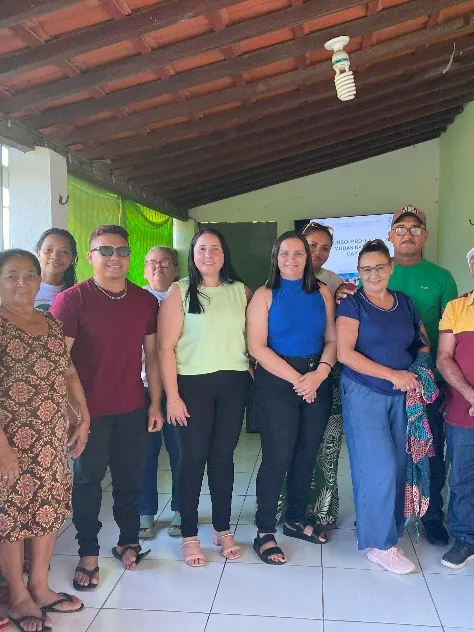 Instructors and participants posing for a group photograph inside the classroom.
