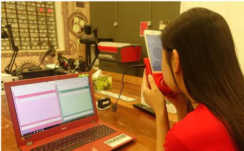 Fig. 9: A participant giving a kiss to a player using the haptic kissing device during the Imitation Game experiment