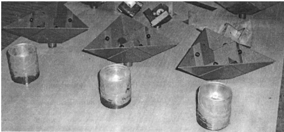 Fig. 2: Copper shells and stainless steel ball showing wear debris, track and transferred film Fig. 3. Specimen holders & lubricant containers: cylindrical for shells, in the front row; octant for circular discs, in the rear row. Fig. 3: Specimen holders & lubricant containers row: Cylindrical shape Rear row: Octant shape