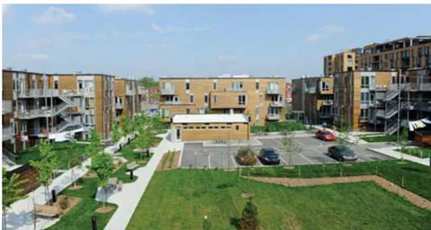 Figure 6: An affordable, low rise, energy efficient multi-unit residential building "Atelier Rosemount" in Montreal, note the rain retention basin in the bottom right (credit Nikkol Rot)